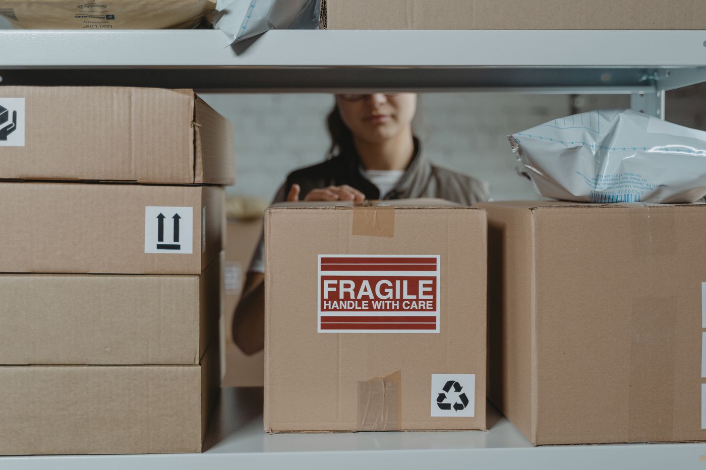 Boxes marked fragile being packed for shipment